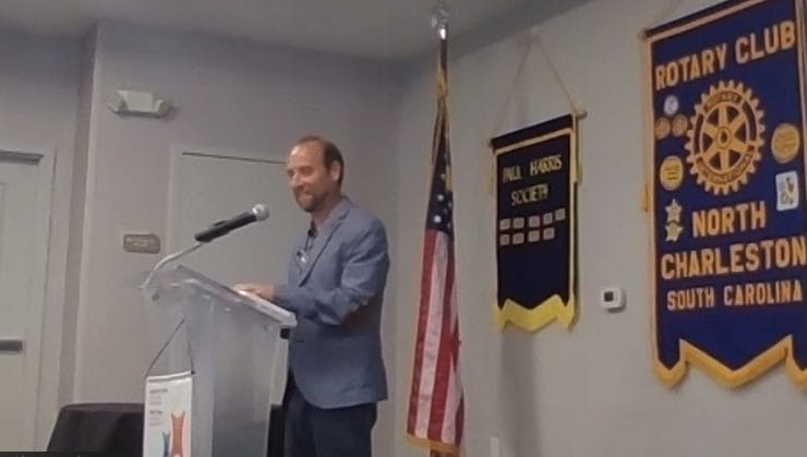 Photo of Ryan Padgett leading the North Charleston Rotary Club meeting