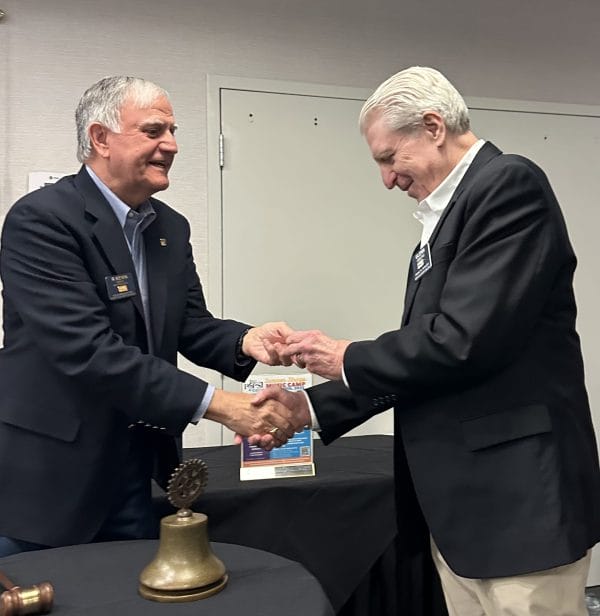 Photo (l-r) Kevin Isaac giving a Paul Harris Fellow +3 pin to Glenn Gibbons